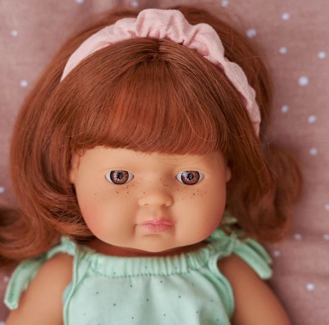Boneca com cabelo castanho-avermelhado e vestido verde-água