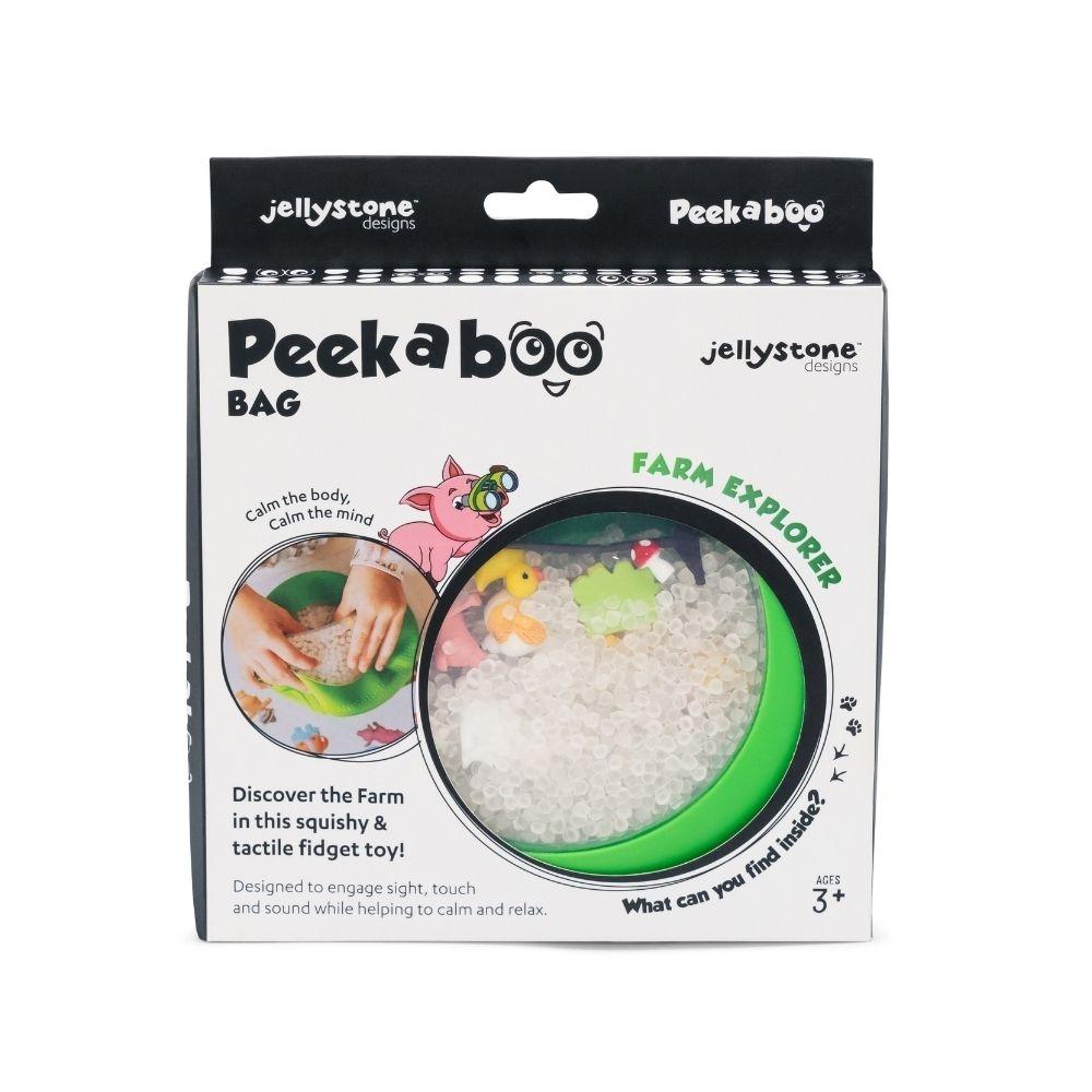Embalagem de Peekaboo Bag com janela circular mostrando brinquedos e enchimento branco, texto e ilustração de porco.