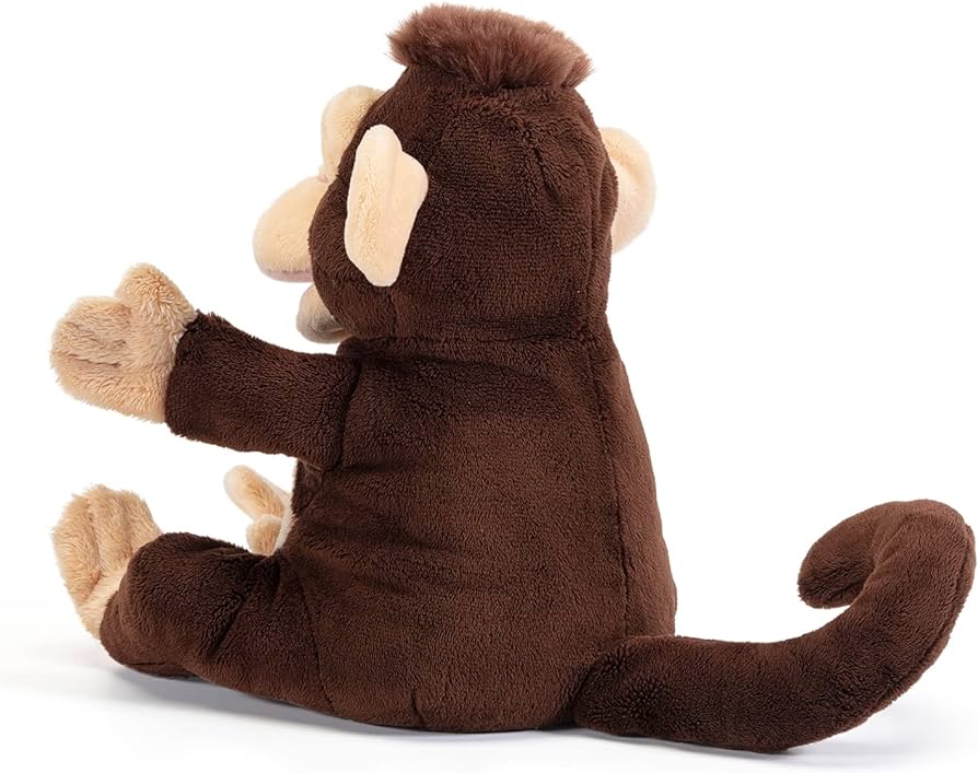 Pelúcia de macaco castanho escuro sentada de lado