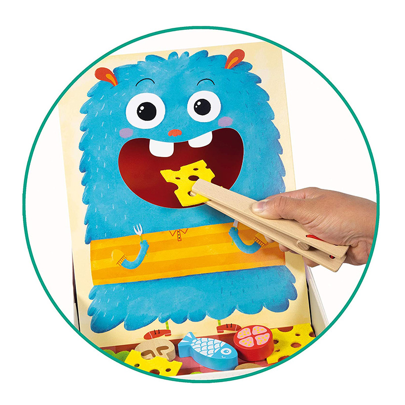 Brinquedo educativo com monstro azul e pinças de madeira a alimentar alimentos ilustrados