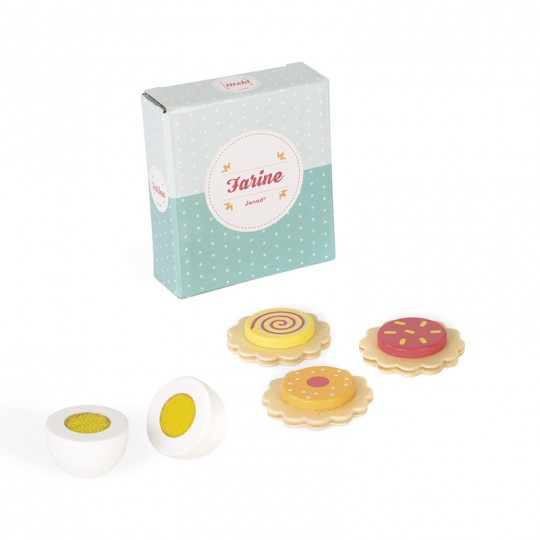 Caixa de brinquedo azul clara com três bolachas coloridas e dois ovos de madeira partidos ao meio