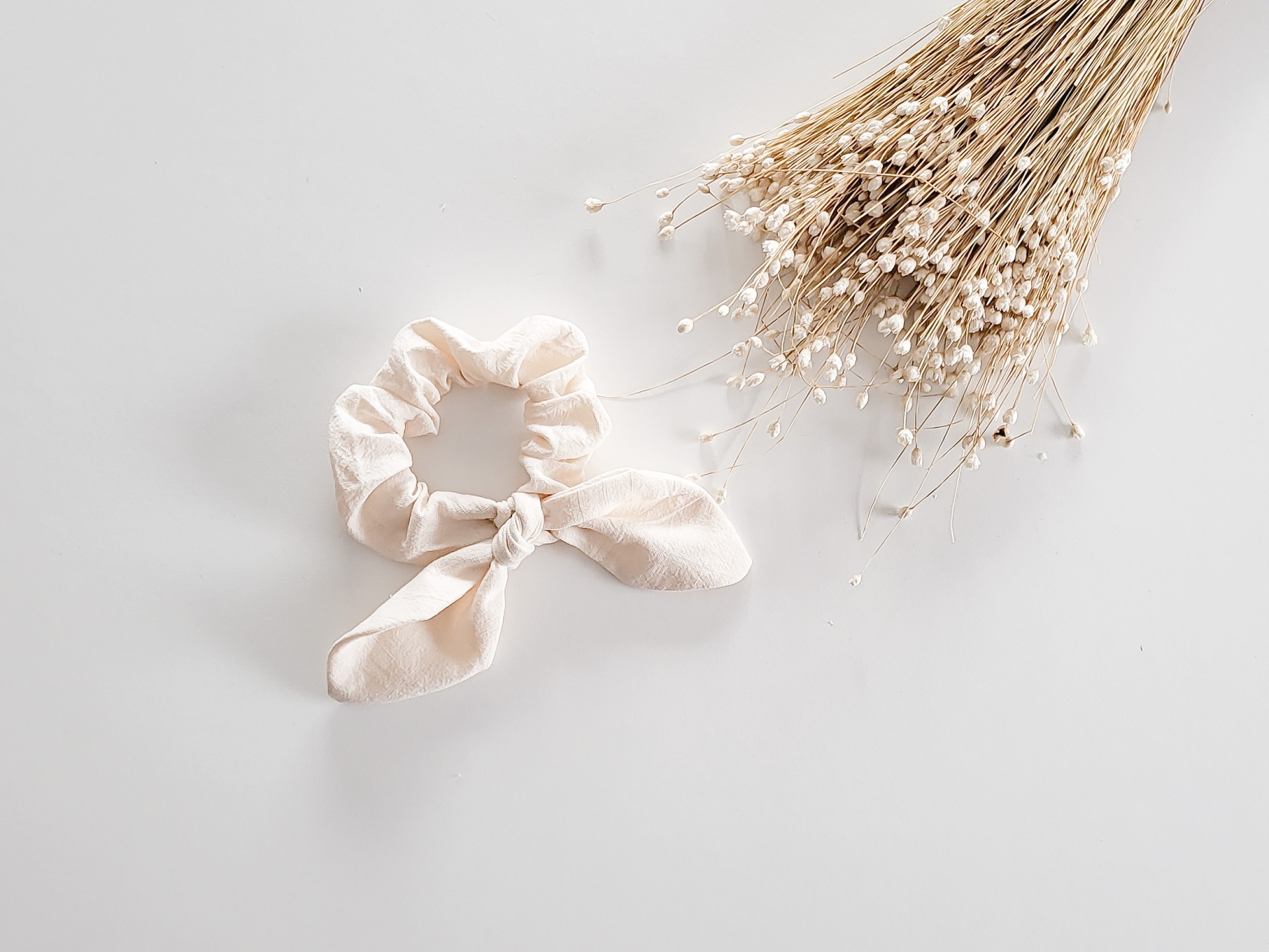 Elástico para cabelo bege com laço e ramo de flores secas