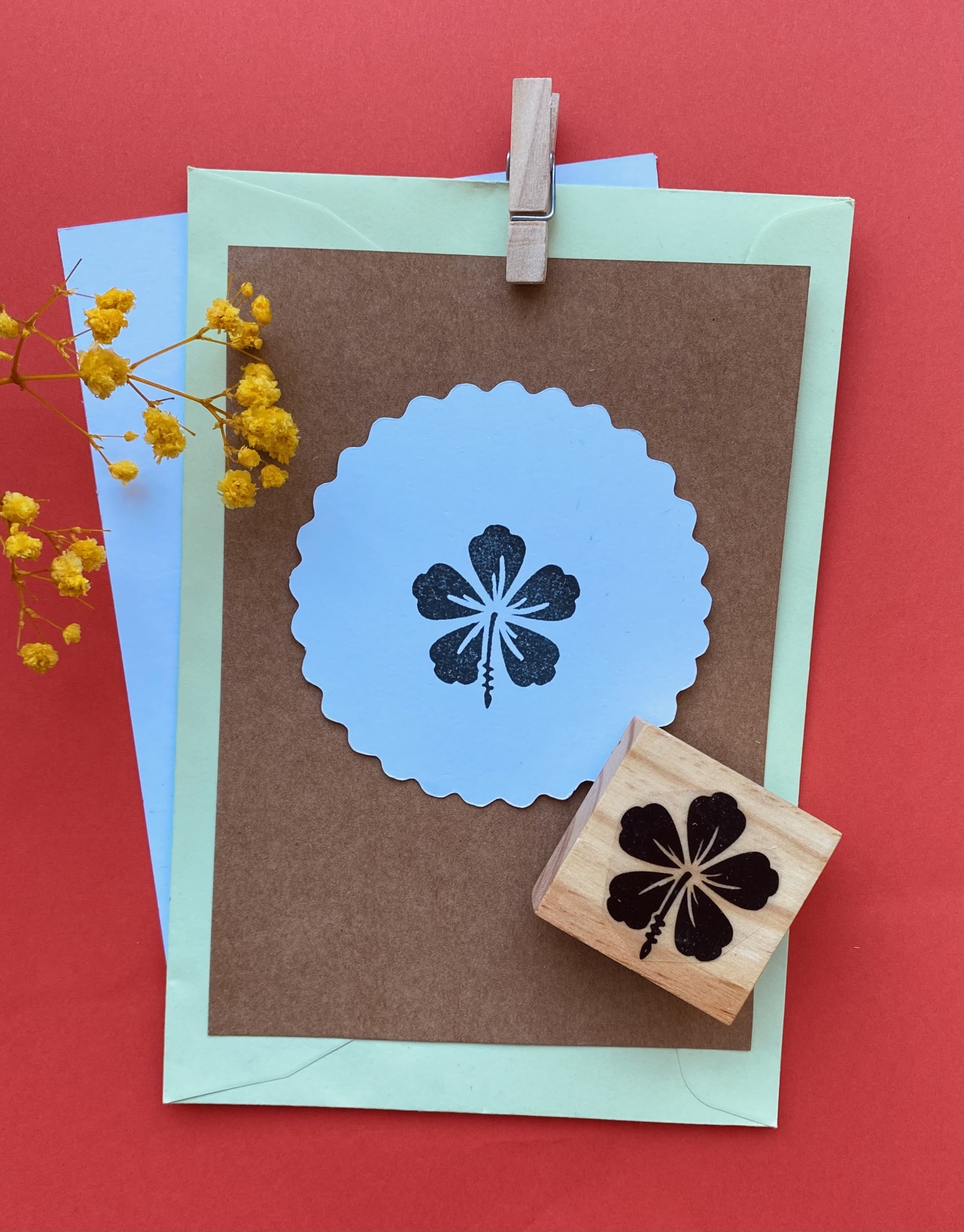 cartões e envelopes com carimbo de trevo preto sobre superfície vermelha