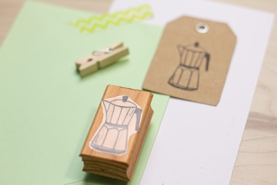 Carimbo de madeira com desenho de cafeteira Moka e etiqueta com o mesmo desenho