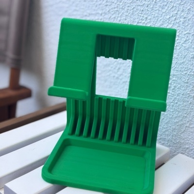 Suporte verde de plástico com superfície branca ao fundo