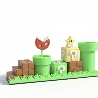 Figura decorativa Super Mario com canos verdes, blocos castanhos, cubos com interrogação e estrela amarela numa base verde com relva