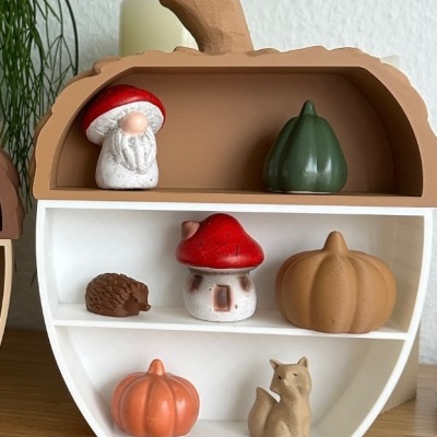 Miniatura decorativa com figuras de cogumelos, abóboras, ouriço-cacheiro e raposa em forma de maçã