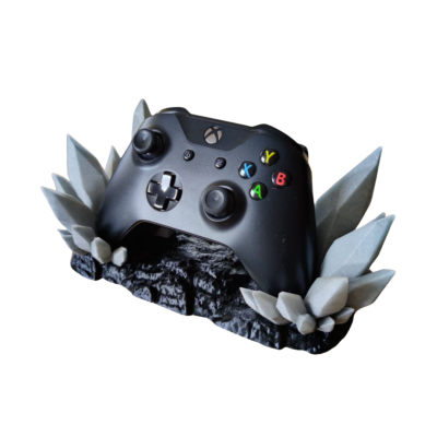 Comando Xbox preto com suporte de pedras cinzentas
