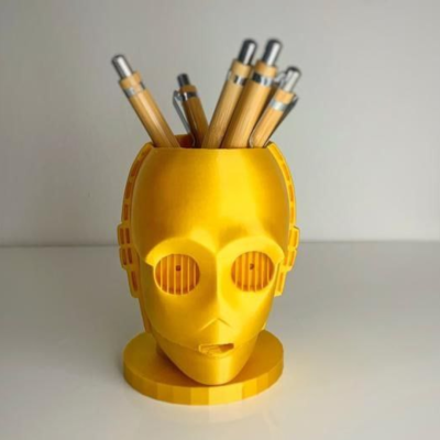 Suporte de secretária amarelo cabeça robótica com canetas de madeira