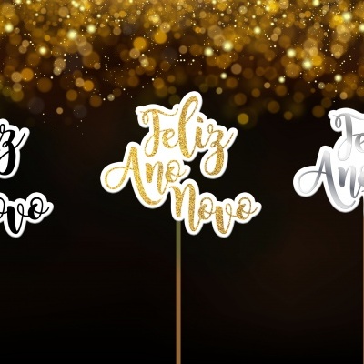 Três decorações para bolo com a frase Feliz Ano Novo em preto, dourado e prateado