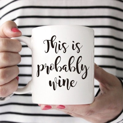 Caneca branca com texto 'This is probably wine'