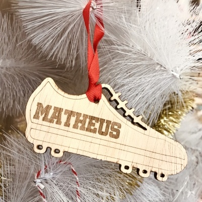 Enfeite de madeira em forma de sapatilha de futebol americano com nome MATHEUS pendurado em árvore branca