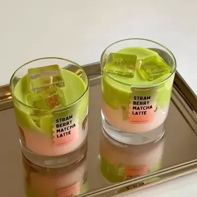Dois copos com bebida rosa e verde e rótulo STRAW BERRY MATCHA LATTE num tabuleiro prateado