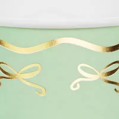 Recipiente cerâmico verde com decoração dourada em forma de laços e linha ondulada