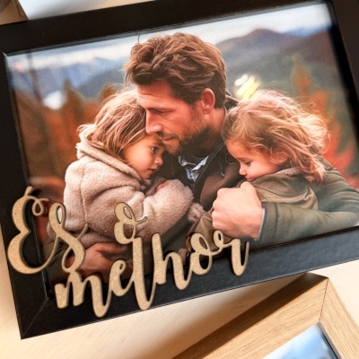 Fotografia emoldurada de um homem com duas crianças e texto decorativo 'És melhor'