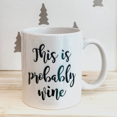 Caneca branca com texto This is probably wine