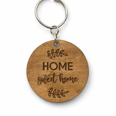 Porta-chaves redondo em madeira com texto HOME sweet home gravado.