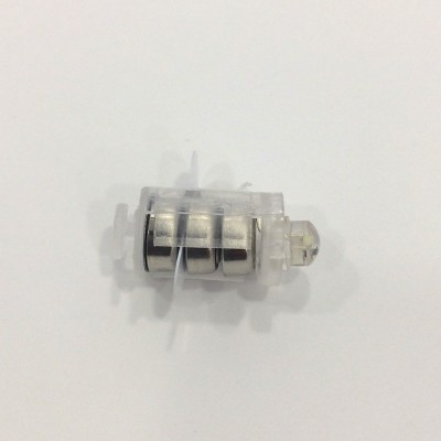 Peça pequena transparente com cilindros metálicos no interior