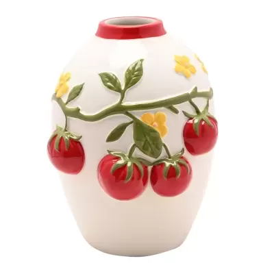 Jarro de cerâmica branca com tomates vermelhos em relevo e flores amarelas.