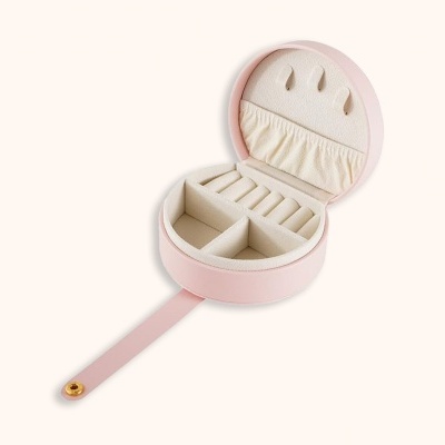 Caixa de joias redonda rosa com interior creme e compartimentos