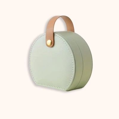 Mala redonda verde clara com alça castanha