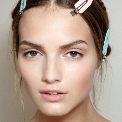 Três ganchos de cabelo coloridos em cabelo castanho claro