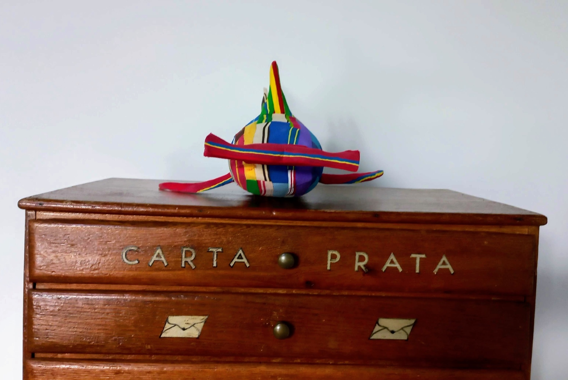 Tubarão Martelo M Cômoda de madeira com chapéu colorido em cima