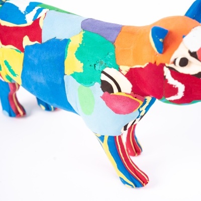 Escultura de cão colorido em tecido sobre fundo branco