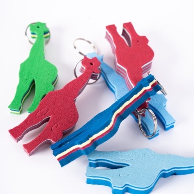 Porta-chaves em espuma coloridos com formas de dinossauros e tiras com riscas
