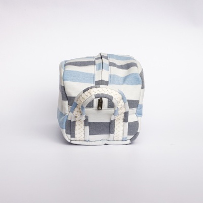 Mochila pequena azul, branca e cinza com riscas em fundo branco