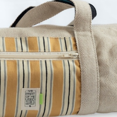 Mala de tecido com riscas amarelas e etiqueta com texto