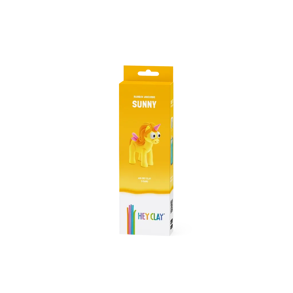 Embalagem amarela com unicórnio amarelo e crina laranja, texto RAINBOW UNICORN SUNNY e HEY CLAY.