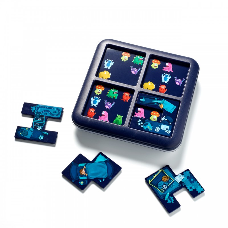 Jogo de encaixe com peças coloridas de monstros e objetos em tabuleiro azul escuro.