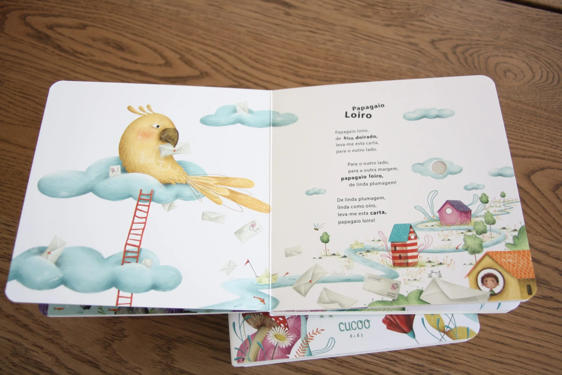 Livro infantil aberto mostrando pássaro amarelo e texto em português.