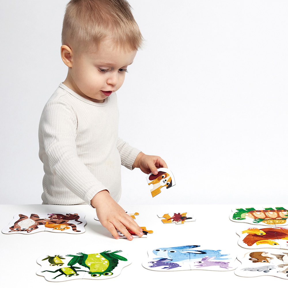 Criança a montar puzzle de animais coloridos