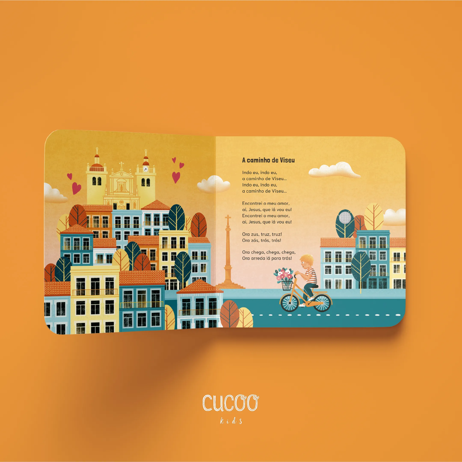 Livro infantil aberto com ilustração de cidade e criança em bicicleta