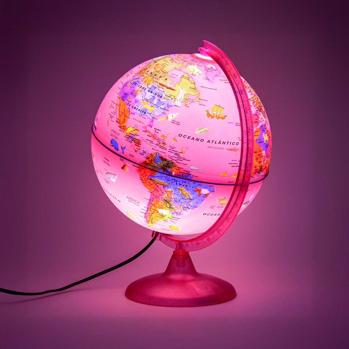 Globo terrestre iluminado com suporte rosa em fundo cor-de-rosa