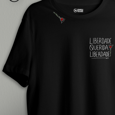 T-shirt preta com estampa de rosa vermelha e texto branco LIBERDADE QUERIDA LIBERDADE