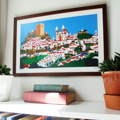 Quadro colorido com paisagem urbana e plantas ao lado