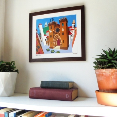 Quadro colorido emoldurado com ilustração de castelo, dois livros antigos e vasos de plantas sobre prateleira branca