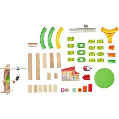 Peças de brinquedo em madeira, plástico e cartão organizadas em fundo branco