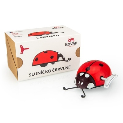 Brinquedo joaninha de metal vermelho com caixa de papelão