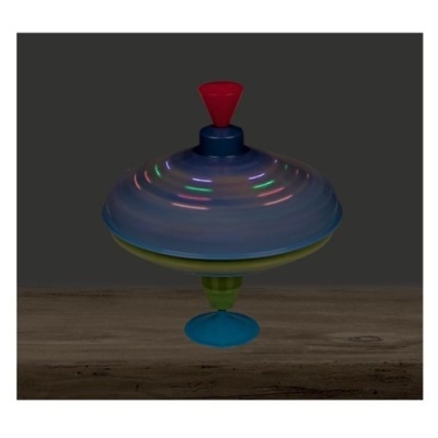 Pião colorido de plástico em movimento sobre madeira clara