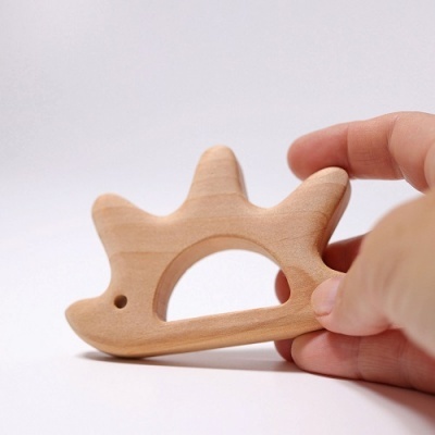 Brinquedo de madeira em forma de porco-espinho com buraco central