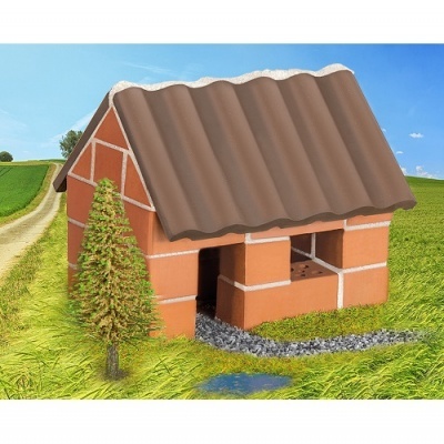 Modelo de casa pequena em tijolos vermelhos com telhado castanho num campo verde