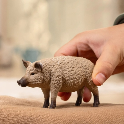 Figura de porco em plástico com textura encaracolada nas cores bege e castanho