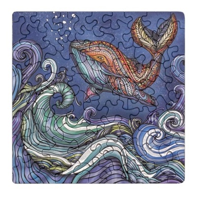 Quebra-cabeças com baleia colorida e ondas do mar em fundo azul escuro