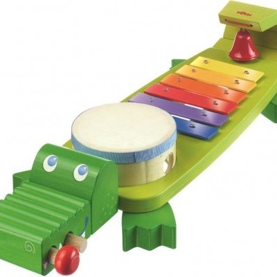 Instrumento musical infantil de madeira em forma de crocodilo com xilofone e tambor