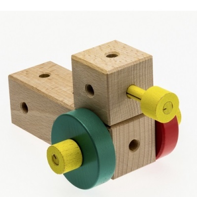 Blocos de madeira naturais com peças coloridas amarelas, verdes e vermelhas com furos, sobre fundo branco.