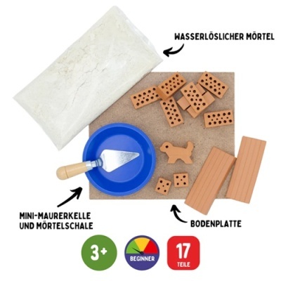 Conjunto mini tijolos e argamassa com utensílios para construir sobre base